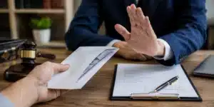 Insurance adjuster reviewing a personal injury settlement offer beside medical bills and accident documentation